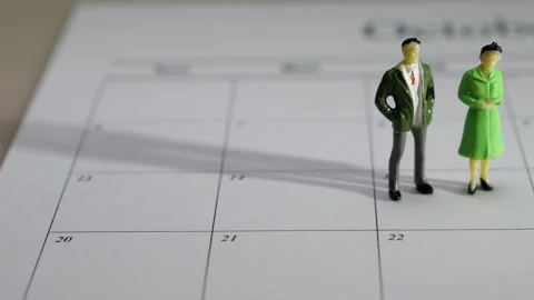 Couple Figurines on a Calendar Stock Footage 243541200