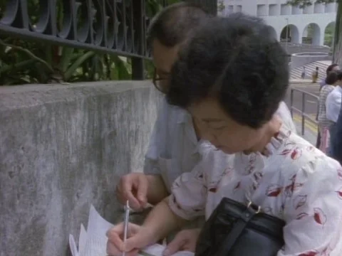 Couple filling the visa forms outside the US Embassy Stock Footage 79878164