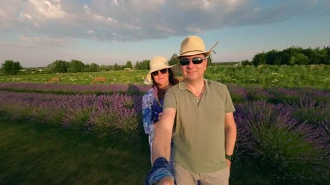 Couple Filming Themselves in Lavender Fields on a Summer Evening Stock Footage 290208277
