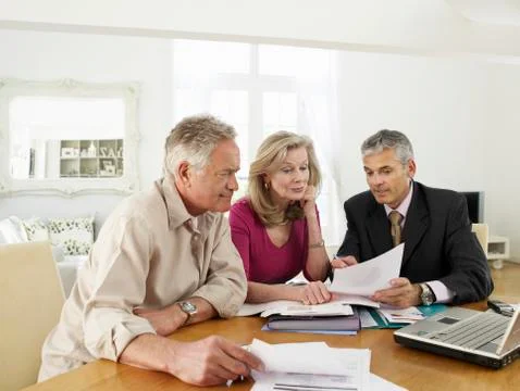 Couple With Financial Advisor At Table Stock Photos