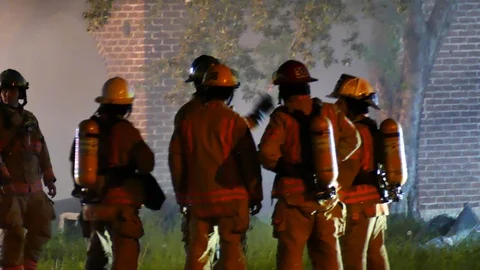 Couple of firemen chatting in group Stock Footage 114765859