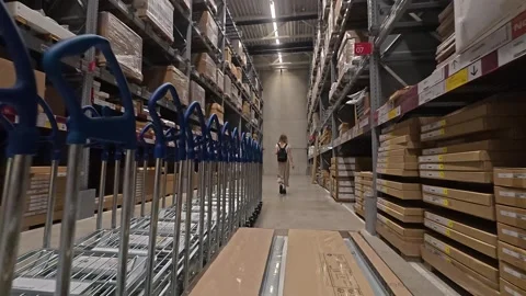 Couple With Flatbed Trolley Browsing A Large Furniture Warehouse Aisle Inside Stockbeeldmateriaal 334179602