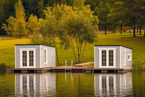 Couple of floating cabins with nice reflection on the lake water Stock Photos