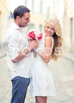 Couple with flowers in the city Stock Photos