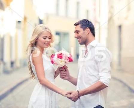 Couple with flowers in the city Stock Photos