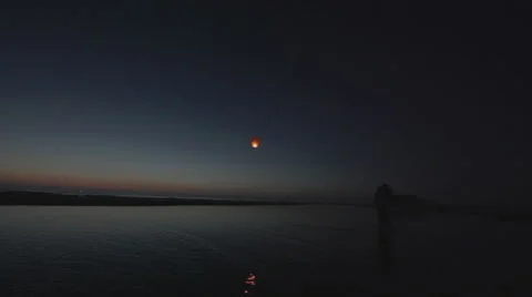 Couple flys a floating asian lantern - static shot - wide Stock Footage 40816737