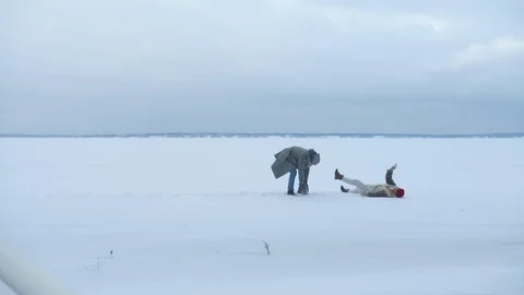 A couple fooling around and throwing snow Stock Footage 129095376