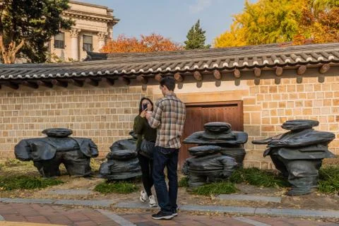 Couple in front of statues Stock Photos