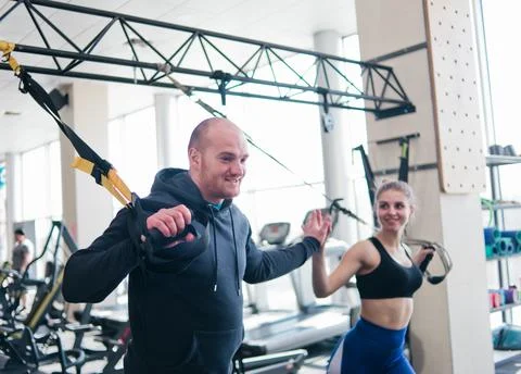 Couple functional training. High five. Woman and man doing exercise with fitn Stock Photos