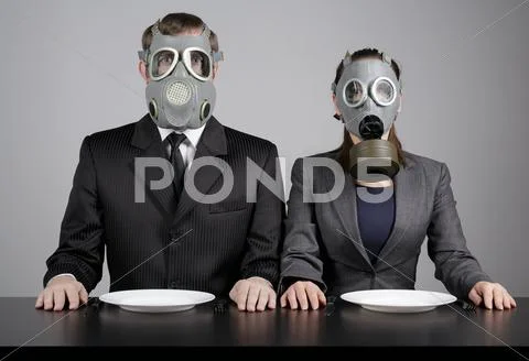 Couple at gas masks Stock Photos