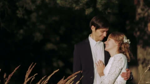 Couple Gently Hugging in a Field of Wheat Stock Footage 62351044