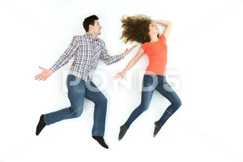 The couple gesture on the white floor. View from above Stock Photos