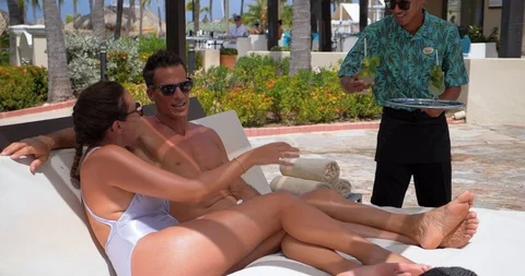 Couple Gets Tropical Drinks Poolside at Resort Pool Видео 103220571
