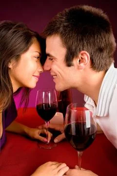 Couple getting closer while having wine Stock Photos