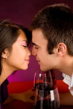Couple getting closer while having wine Stock Photos