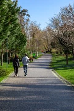 Couple going for a relaxing fitness walk in Parque da Devesa Urban Park. Stock Photos