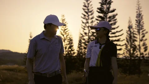 Couple Golfing player talking about nice shot in golf course Stock Footage 120027860