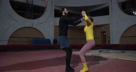 Couple of gymnasts are training before the performance, man and woman, 4k Stock Footage 147191810