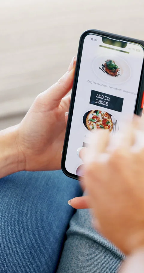 Couple, hands and phone screen with food menu on sofa for restaurant website, 動画素材 336840722
