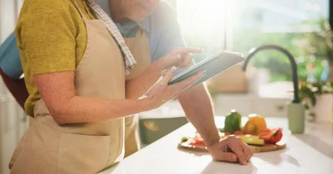 Couple, hands or app with tablet in kitchen for online cooking tutorial or .. Stock Photos