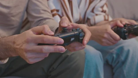 Couple Hands Using Controllers while Playing Video Game Stock Footage 232933451