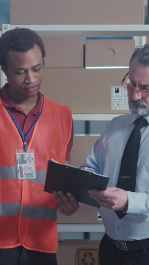 Couple of handsome men cooperating at post office company. Caucasian and african Stock Footage 313788421
