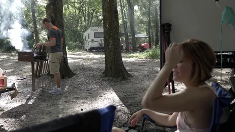 Couple Hangs Outside 5th Wheel Camper While Grilling Stock Footage