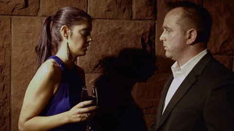 A couple has a conversation by a wall Stock Footage 42894384