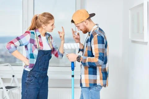 Couple has different points of view about home repair but try to make joke of it Stock Photos