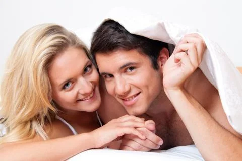 Couple has fun in bed Stock Photos