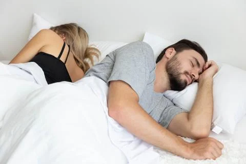 A Couple has problem and sleep by turn back to each other Stock Photos
