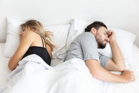 A Couple has problem and sleep by turn back to each other Stock Photos
