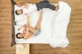 The couple have a fun on the bed. View from above Photo