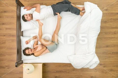 The couple have a fun on the bed. View from above Stock Photos