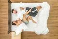 The couple have a fun on the bed. View from above Photo