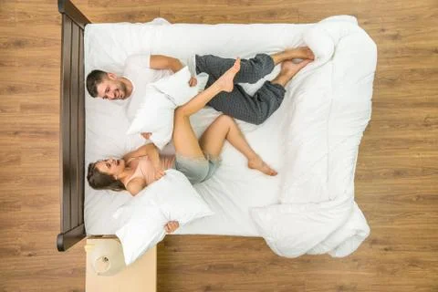 The couple have a fun on the bed. View from above Fotos Stock
