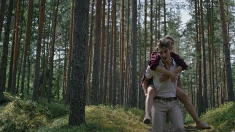 Couple have fun, run in forest on piggy back Stock Footage 162041205