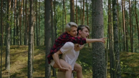 Couple have fun, run in forest on piggy back Stock Footage 162041614