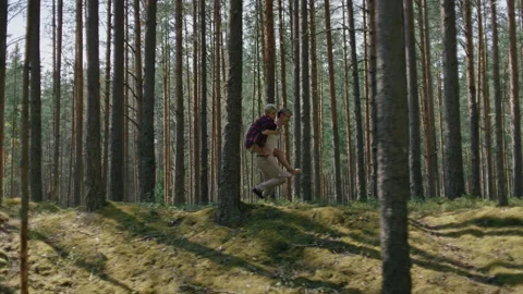 Couple have fun, run in forest on piggy back Stock Footage 162724002