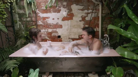 A couple having an argument while in an outdoor bath. Video stock 170437914