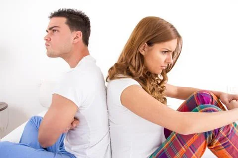 Couple having an argument while they sitting on bed Stock Photos