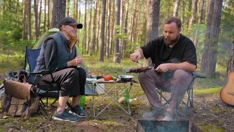 Couple having a barbecue while camping in the forest Stock Footage 327131786