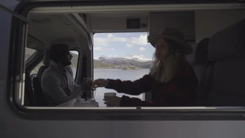 Couple having beverage in the caravan Stock Footage 85828840