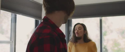 Couple having a big fight by the kitchen window. Accusing of cheating Stock Footage 131498435