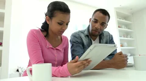Couple Having Breakfast And Using Digital Tablet In Kitchen Stock Footage