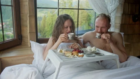 Couple having breakfast in bed Stock Footage 220374378