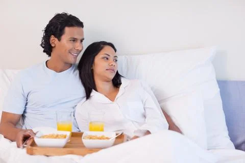Couple having breakfast in the bed Stock Photos