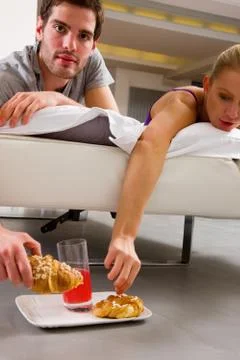 Couple having breakfast in bed Stock Photos