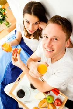 Couple Having Breakfast In Bed Photos