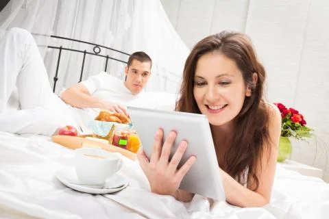 Couple Having Breakfast In Bed Stockfoto's